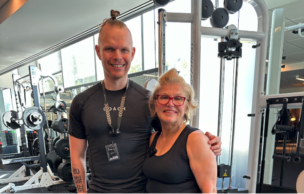 Dr. Susan Chobanian smiling with her fitness trainer at the gym